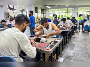 Workers stitch cricket balls at the world's largest cricket gear manufacturer Sanspareils Greenlands (SG) factory as Cricket World Cup 2023 commences in India