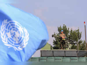 A member of the mine clearance team is pictured behind a UN flag during a tour by France's defence minister of the French contingent's United Nations Interim Forces in Lebanon (UNIFIL) base in the southern Lebanese village of Deir Kifa on November 2, 2023.