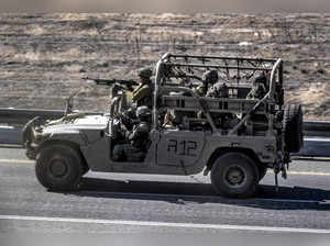Israeli army soldiers sit in a humvee moving along a highway near the border with the Gaza Strip in southern Israel on November 3, 2023 amid the ongoing battles between Israel and the Palestinian group Hamas in the Gaza Strip.