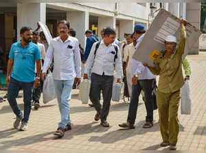 Karad: Polling officials with EVMs and other election material leave for poll du...