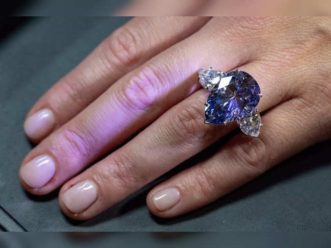 Christie’s auction house intern holds the 'Bleu Royal' diamond.