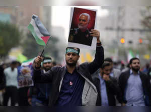 A demonstrator holds a poster of the late Iranian Revolutionary Guard Gen. Qasse...