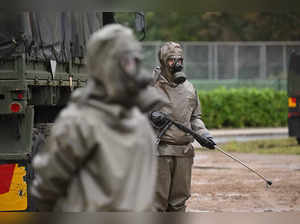 Soldiers of the German armed forces Bundeswehr demonstrate the decontamination of military equipment during the German Chancellor's visit at the military part of the airport in Cologne-Wahn, western Germany, to attend a demonstration of the German army's Homeland Defence Command, on October 23, 2023.