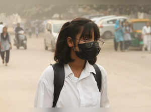 Gurugram, Nov 08 (ANI): A student wearing mask for protection from air pollution...