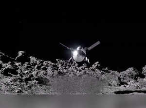 The NASA spacecraft OSIRIS-APEX hovers over the surface of the near-Earth asteroid Apophis