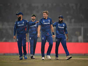 England's David Willey (2R) celebrates with teammates after taking the wicket of Pakistan's Agha Salman during the 2023 ICC Men's Cricket World Cup one-day international (ODI) match between England and Pakistan at the Eden Gardens in Kolkata on November 11, 2023.