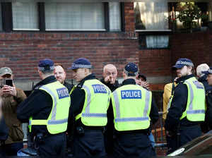 A counter-protester gestures after being detained by police on the margins of a pro-Palestinian demonstration in London
