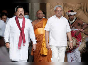 Sri Lanka's Prime Minister Mahinda Rajapaksa and his brother, and Sri Lanka's President Gotabaya Rajapaksa are seen during his during the swearing in ceremony as the new Prime Minister, at Kelaniya Buddhist temple in Colombo