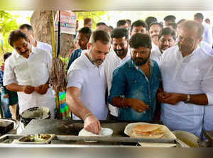 Jagtial: Congress leader Rahul Gandhi makes 'dosa' at a food stall during his vi...