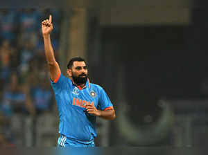 India's Mohammed Shami celebrates after taking the wicket of New Zealand's Devon Conway during the 2023 ICC Men's Cricket World Cup one-day international (ODI) first semi-final match between India and New Zealand at the Wankhede Stadium in Mumbai on November 15, 2023.