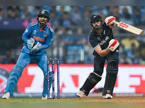 New Zealand's Daryl Mitchell plays a shot as India's KL Rahul (L) watches during the 2023 ICC Men's Cricket World Cup one-day international (ODI) first semi-final match between India and New Zealand at the Wankhede Stadium in Mumbai on November 15, 2023.
