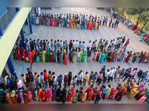 Bhopal: People wait in queue to cast their votes for the Madhya Pradesh Assembly...