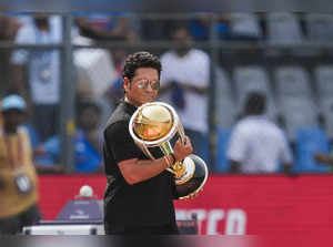 Mumbai: Former Indian cricketer Sachin Tendulkar carrying the ICC Men's Cricket ...