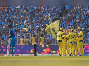 Ahmedabad: Australia's Pat Cummins with teammates celebrates the wicket of India...