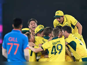 India's Shubman Gill (L) watches as Australia's players celebrate after winning the 2023 ICC Men's Cricket World Cup one-day international (ODI) final match between India and Australia at the Narendra Modi Stadium in Ahmedabad on November 19, 2023.
