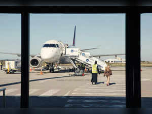 A passenger gets ready to board a plane on the George Airport runaway in George on October 31, 2023.