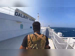 Houthi fighter stands on the Galaxy Leader cargo ship in the Red Sea