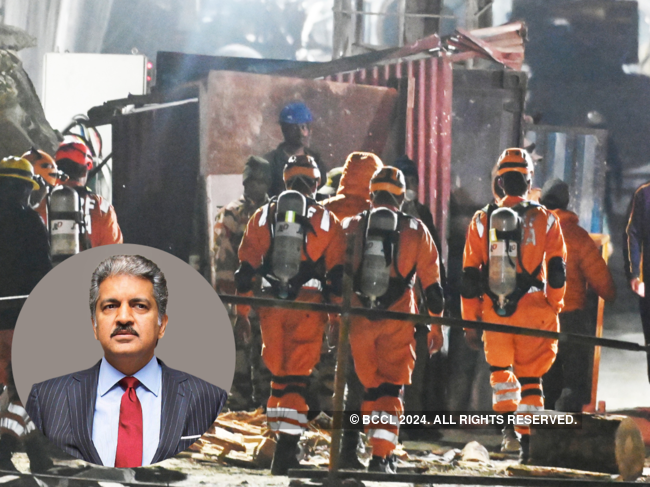 Members of the National Disaster Response Force (NDRF) enter a tunnel where workers have been trapped for ten days.