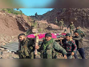 Rajouri_ Army personnel and locals carry the body of an army officer near the si
