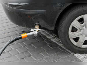 FILE PHOTO: A fuel nozzle of a liquefied petroleum gas pump is plugged to a car's fuel tank at the SOCAR Energy gas station in Kiev