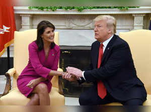 US President Donald Trump shakes hands with Nikki Haley, the United States Ambassador to the United Nations  in the Oval office of the White House on October 9, 2018 in Washington, DC.