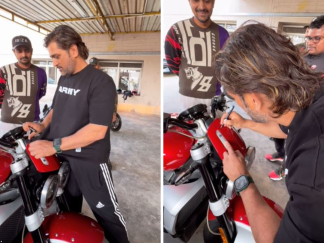 ​MS Dhoni​ cleaning & signing fan's bike.