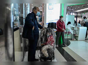 Children and their parents wait at an outpatient area at a children hospital in Beijing on November 23, 2023.