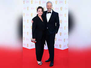 Olivia Colman looks smitten with husband Ed Sinclair as the couple makes a rare red carpet appearance