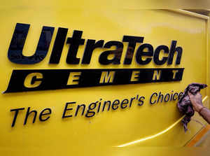 FILE PHOTO: A man cleans an Expert Testing Van of UltraTech Cement outside a cement store in Ahmedabad