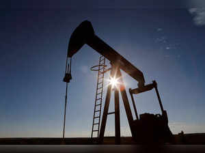 FILE PHOTO: The sun is seen behind a crude oil pump jack in the Permian Basin in Loving County