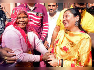 Bikaner, Nov 25 (ANI): BJP candidate Siddhi Kumari interacts with a women after ...