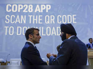 France's President Emmanuel Macron (L) listens to World Bank President Ajay Banga during the Transforming Climate Finance session at the United Nations climate summit in Dubai on December 1, 2023.