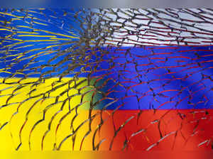 FILE PHOTO: Illustration shows Ukraine and Russian flags through broken glass
