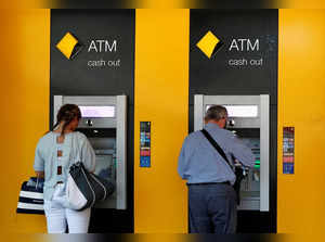 FILE PHOTO: People use Commonwealth Bank of Australia (CBA) bank ATMs in Sydney