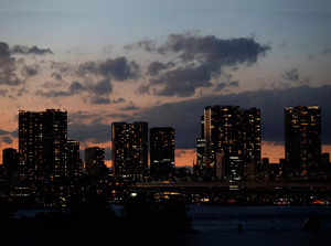 High-rise apartment buildings and high-rise office buildings are seen at dusk in Tokyo