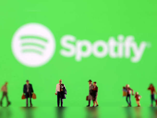 FILE PHOTO: Illustration shows small figurines and displayed Spotify logo
