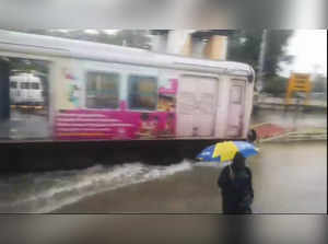 **EDS: VIDEO GRAB** Chennai: A train runs on a waterlogged railway track after h...
