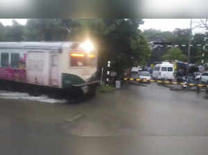 **EDS: VIDEO GRAB** Chennai: A train runs on a waterlogged railway track after h...