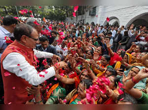 Chief Minister of Madhya Pradesh and member of Bharatiya Janata Party (BJP) Shivraj Singh Chouhan (2L) is greeted by his supporters at his residence in Bhopal on December 3, 2023, following BJP's victory at the Madhya Pradesh assembly elections.
