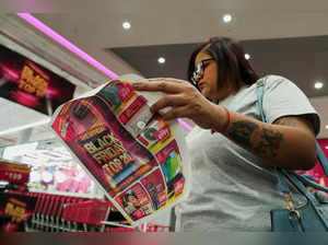 Shopper reads a Black Friday advertisement booklet at Game store in Johannesburg
