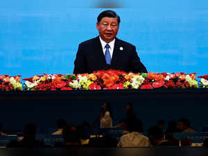 FILE PHOTO: Journalists watch a giant screen broadcasting footage of Chinese President Xi Jinping at the opening ceremony of BRF in Beijing