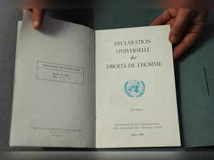 This photograph taken on December 9, 2023, shows a document from the Department of Information of the United Nations, dated March 1949, bearing the French text of the "Declaration Universelle des Droits de l'Homme" (Universal Declaration of Human Rights) adopted and proclaimed by the General Assembly of the United Nations on December 10, 1948, displayed by an employee at the Bibliotheque Nationale de France (BnF - French National Library) in Paris.