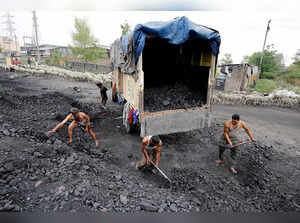 FILE PHOTO: Labourers load coal onto a supply truck on the outskirts of Jammu