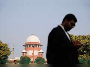 A lawyer looks into his mobile phone in front India's Supreme Court in New Delhi