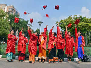Students toss their graduation caps