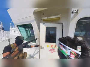 Houthi fighters open the door of cockpit on the ship's deck in the Red Sea