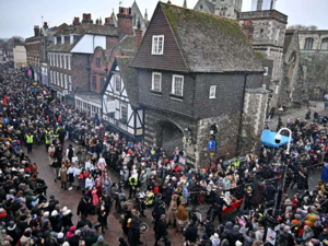 Enthusiasts in period costume take part in a parade during the 'Dickensian Christmas Festival' in Rochester, south east England, on December 2, 2023. Than annual festival sets to bring Victorian festivities in the form of a Dickensian Christmas, with attendees dressing as characters from the author Charles Dickens' books.
