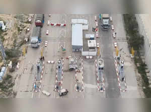 Humanitarian aid trucks wait in line to be inspected at the Kerem Shalom crossing