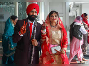 Jammu: A newly wedded Sikh couple poses for photos, in Jammu. The J&K administra...