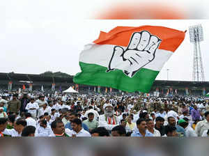 A Congress party supporter waves the party's flag during a swearing in ceremony of Telangana government, in Hyderabad on December